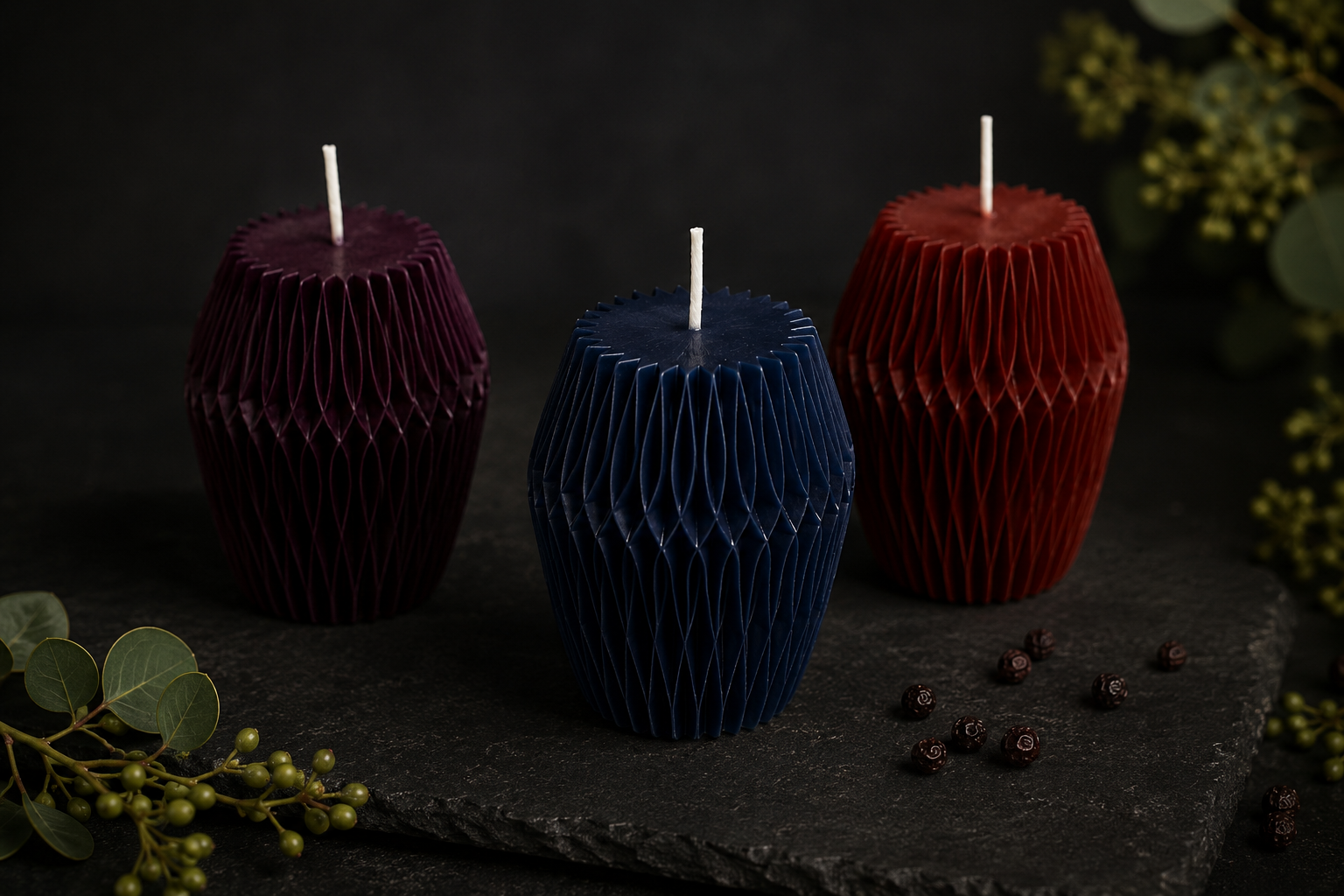 Glow Pantry Facet Collection featuring handcrafted sculptural candles in Mulberry, Midnight and Ember, displayed on a dark botanical backdrop.