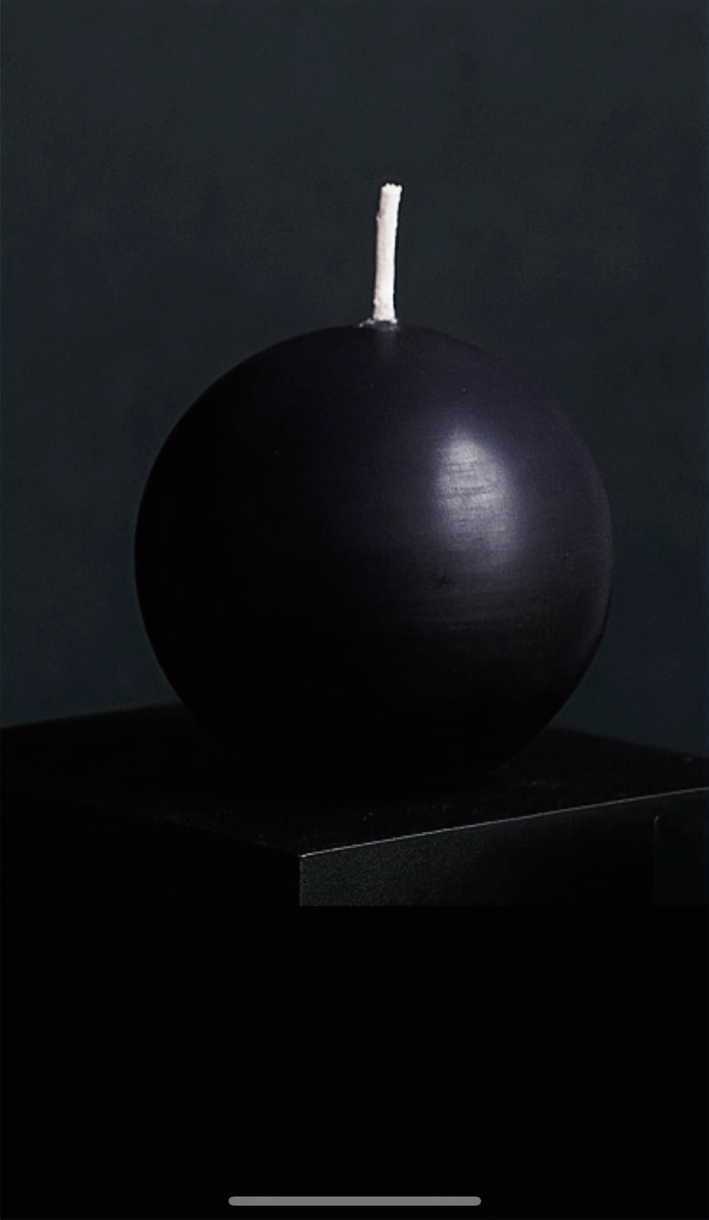 Nocturne Sphere sculptural pillar candle in deep matte black with spherical design, displayed against a dark studio background, handcrafted by Glow Pantry.