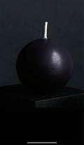 Nocturne Sphere sculptural pillar candle in deep matte black with spherical design, displayed against a dark studio background, handcrafted by Glow Pantry.