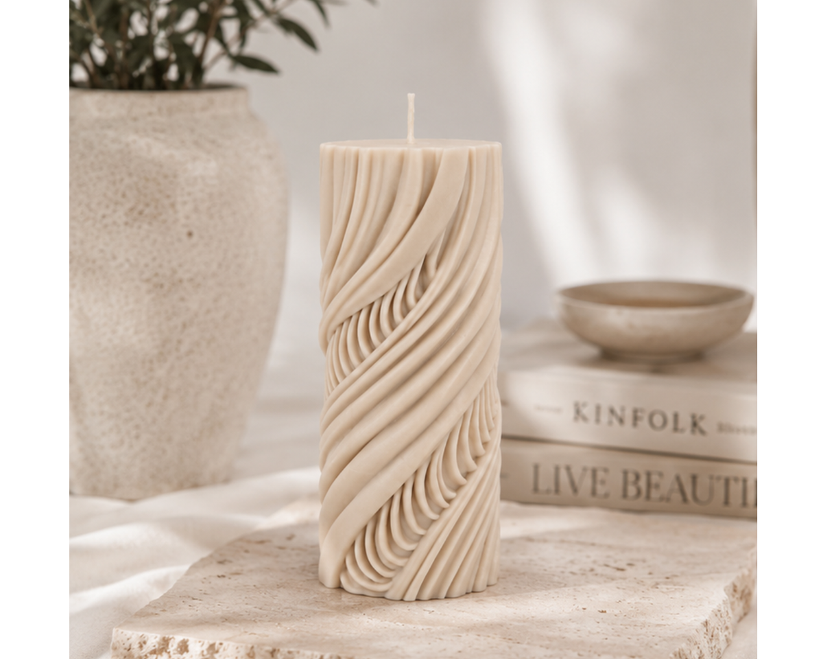Cashmere Obsidian Current decorative pillar candle displayed on a travertine slab with neutral styling and minimalist home décor.