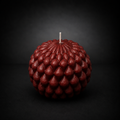 Ember Obsidian Bloom sculptural candle with layered petal texture on a dark, lowlight background