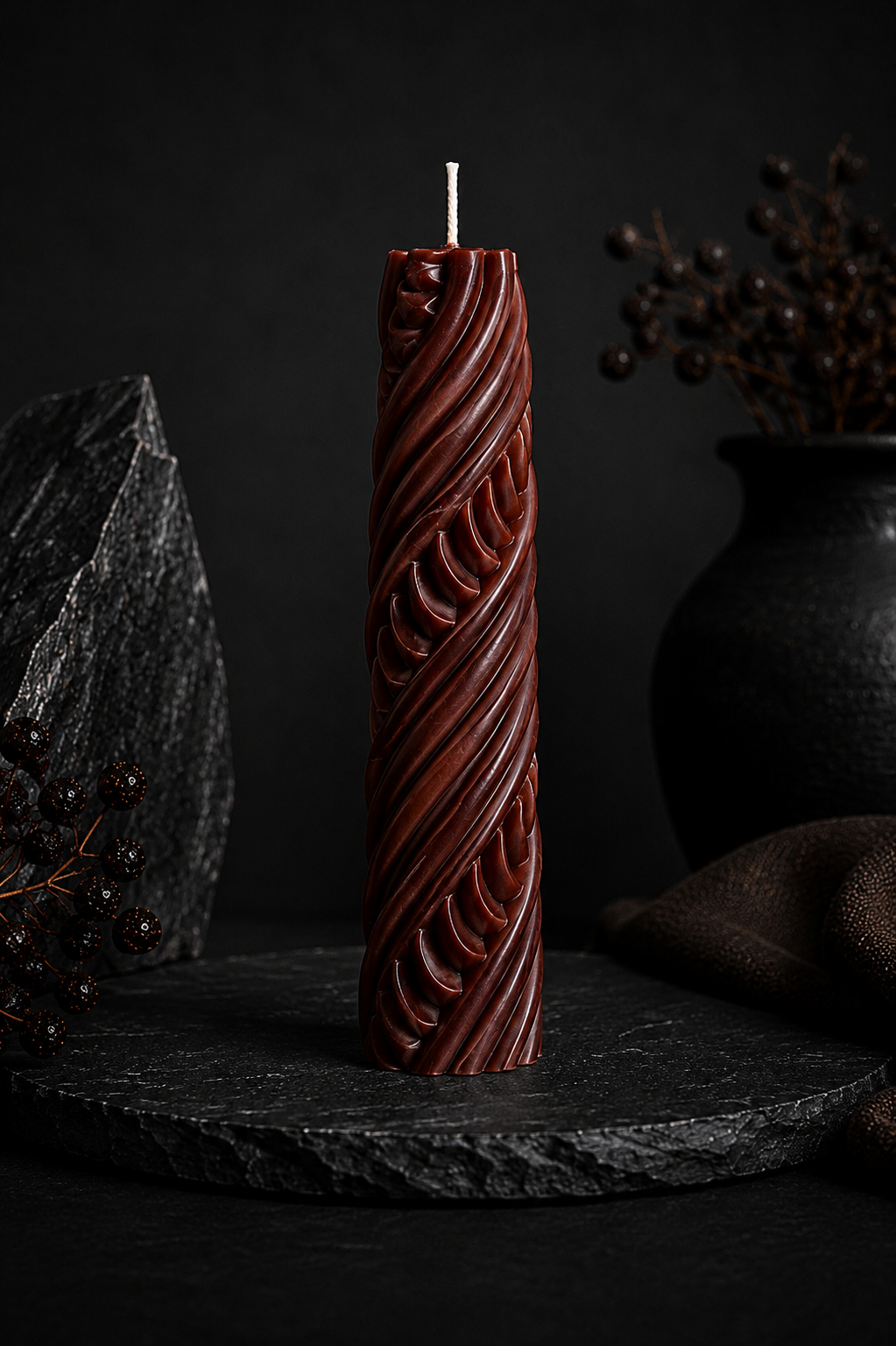 Obsidian Twist sculptural candle in Ember red with carved sculptural texture.