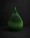Emerald Veil textured sculptural candle with layered forest green tones against a charcoal editorial background.