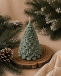 Fleur Fir sculptural Christmas tree candle in muted Eucalyptus Stone, intricately detailed with cascading flowers and leaves.