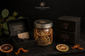 Glow Pantry Discovery Collection featuring sculptural candles, a dried citrus jar, Rare Find discovery items and stacked luxury gift boxes displayed against a dark editorial background.