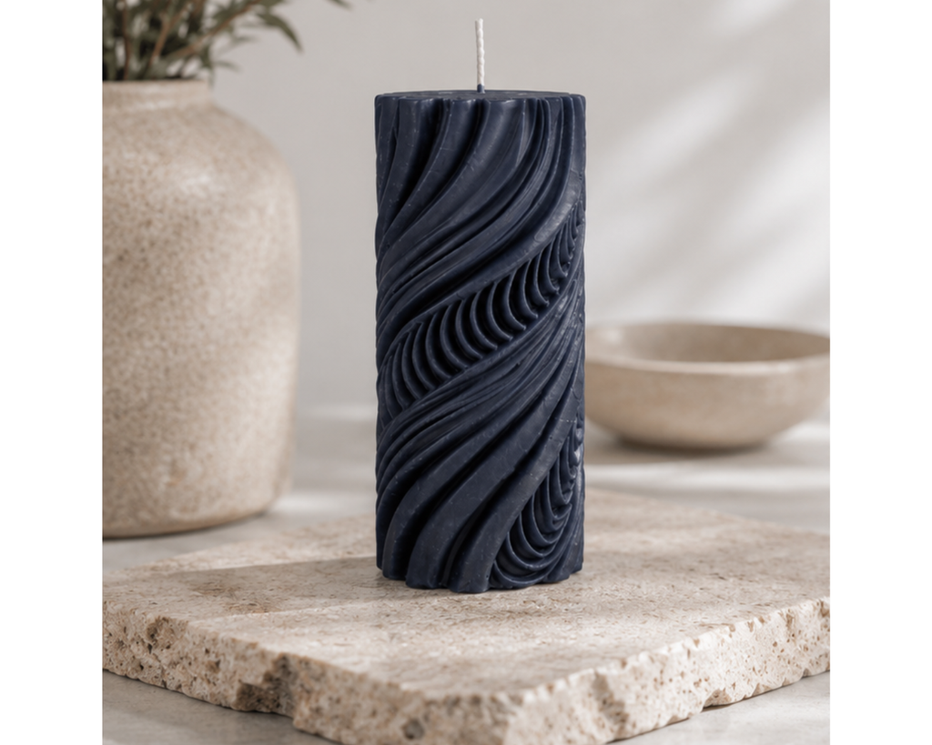 Midnight Obsidian Current decorative pillar candle on a natural stone slab with a textured ceramic vase and minimalist styling.