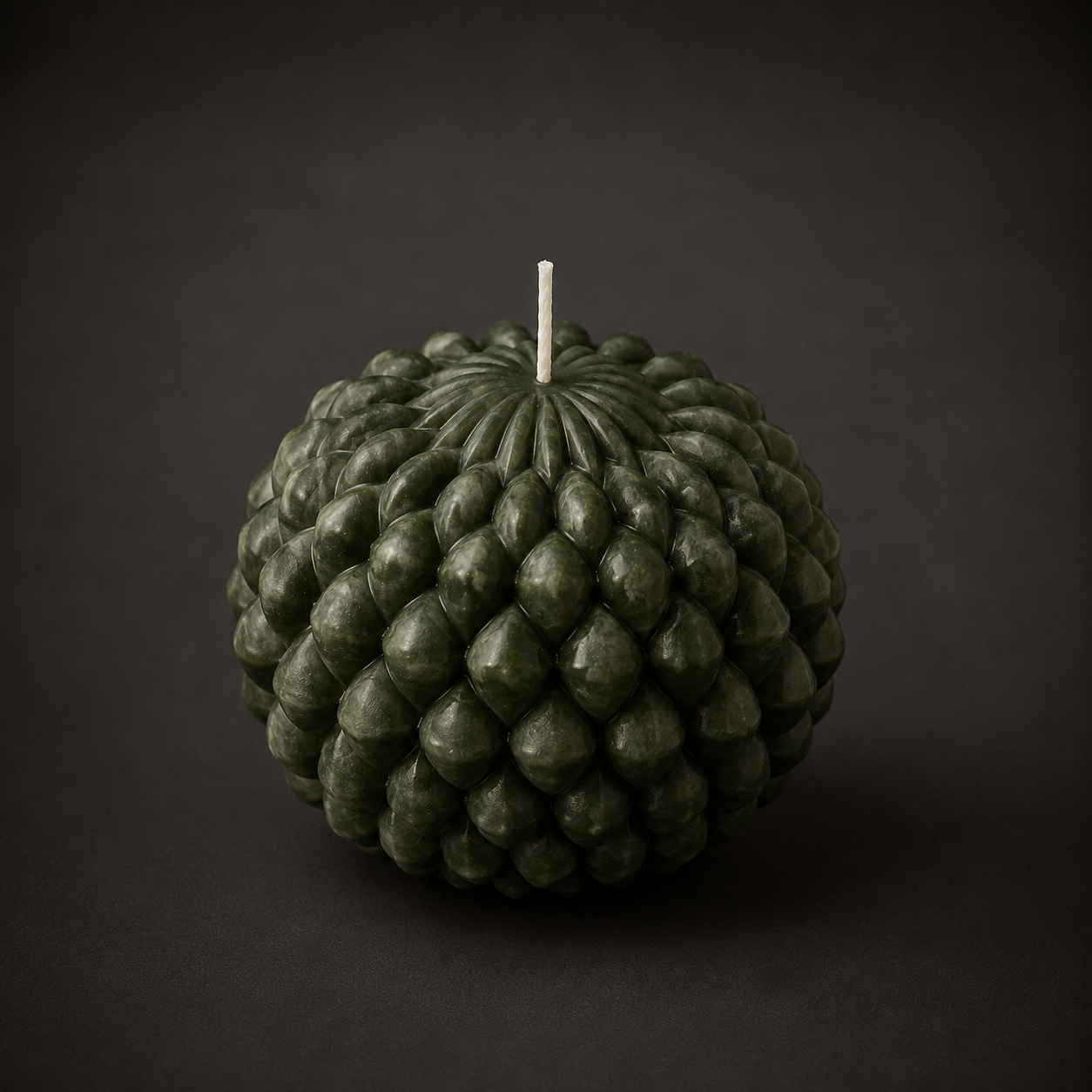 Obsidian Bloom sculptural candle in Moss, featuring a layered petal-inspired form in deep forest green wax. Photographed against a dark backdrop to emphasise the candle’s texture, colour depth and handcrafted detail.