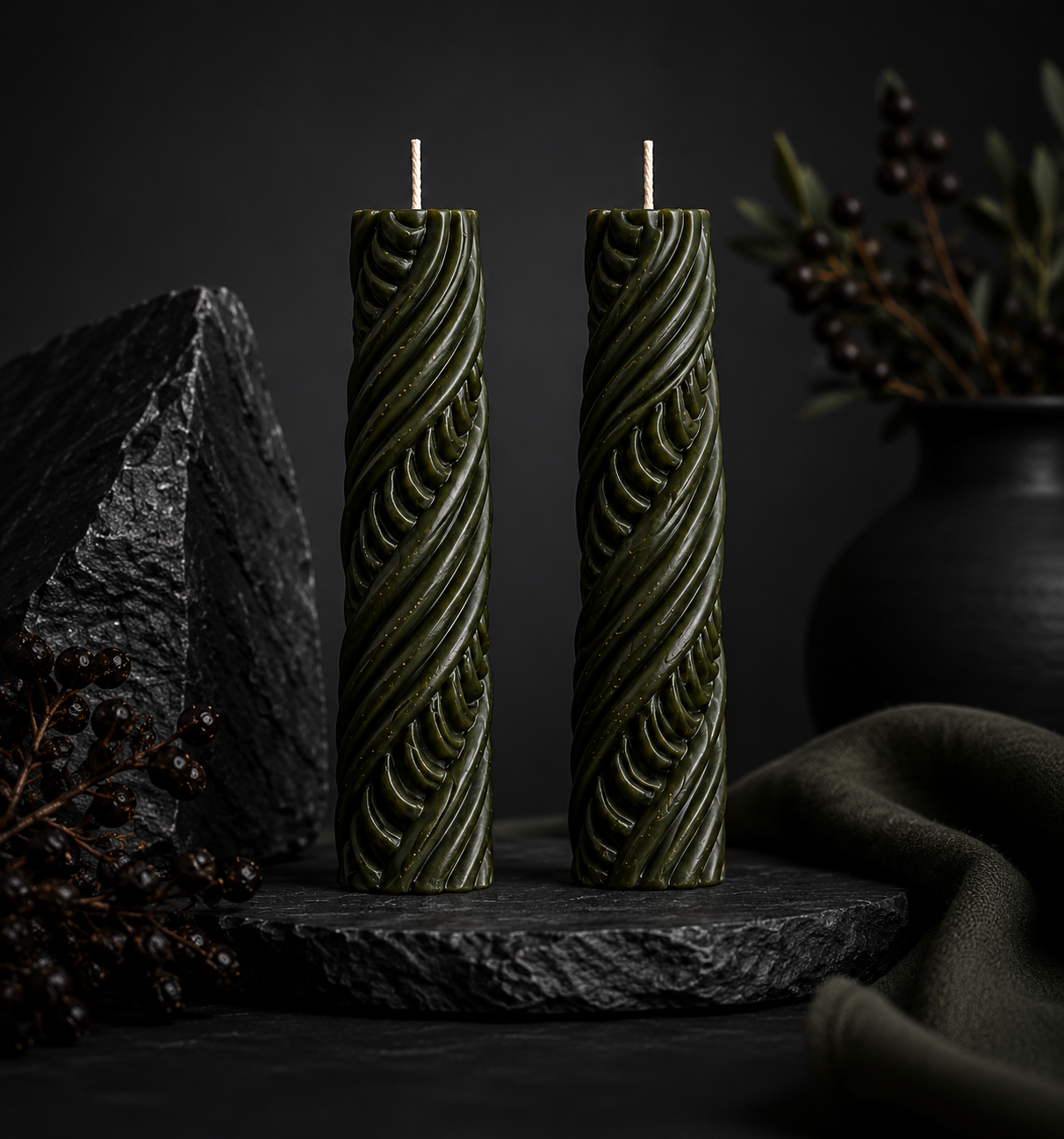Pair of Obsidian Twist sculptural candles in Moss green from the Lowlight Series.