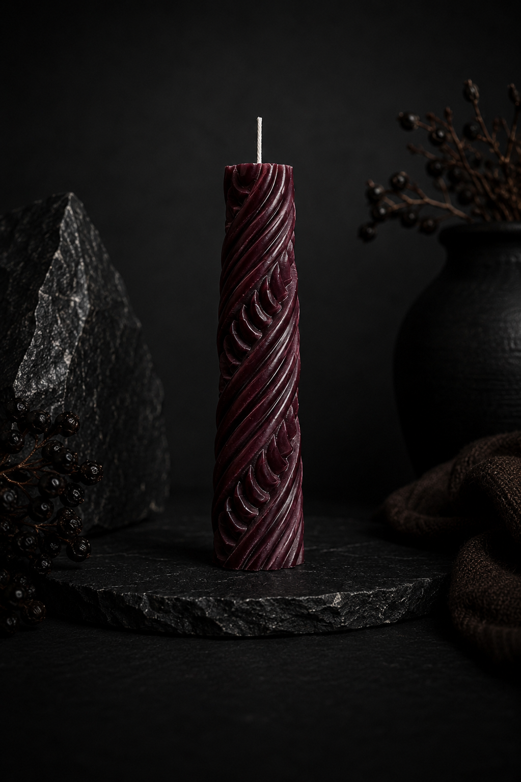Obsidian Twist sculptural candle in Mulberry deep berry tone with carved ribbon texture.