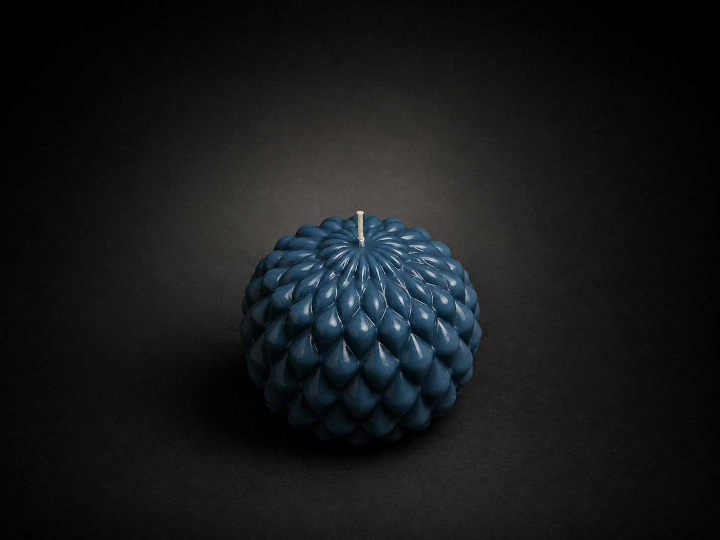 Slate Obsidian Bloom sculptural candle with layered petal texture on a dark lowlight background