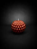 Ember Obsidian Bloom sculptural candle with layered petal texture on a dark, lowlight background