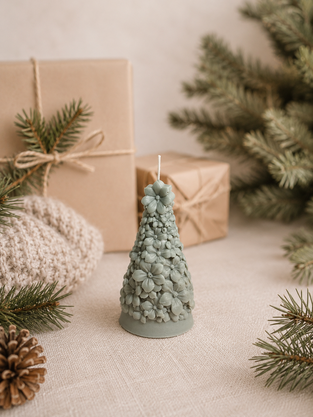 Winterbloom Fir sculptural Christmas tree candle in muted Eucalyptus Stone, featuring intricate floral blossom detailing.