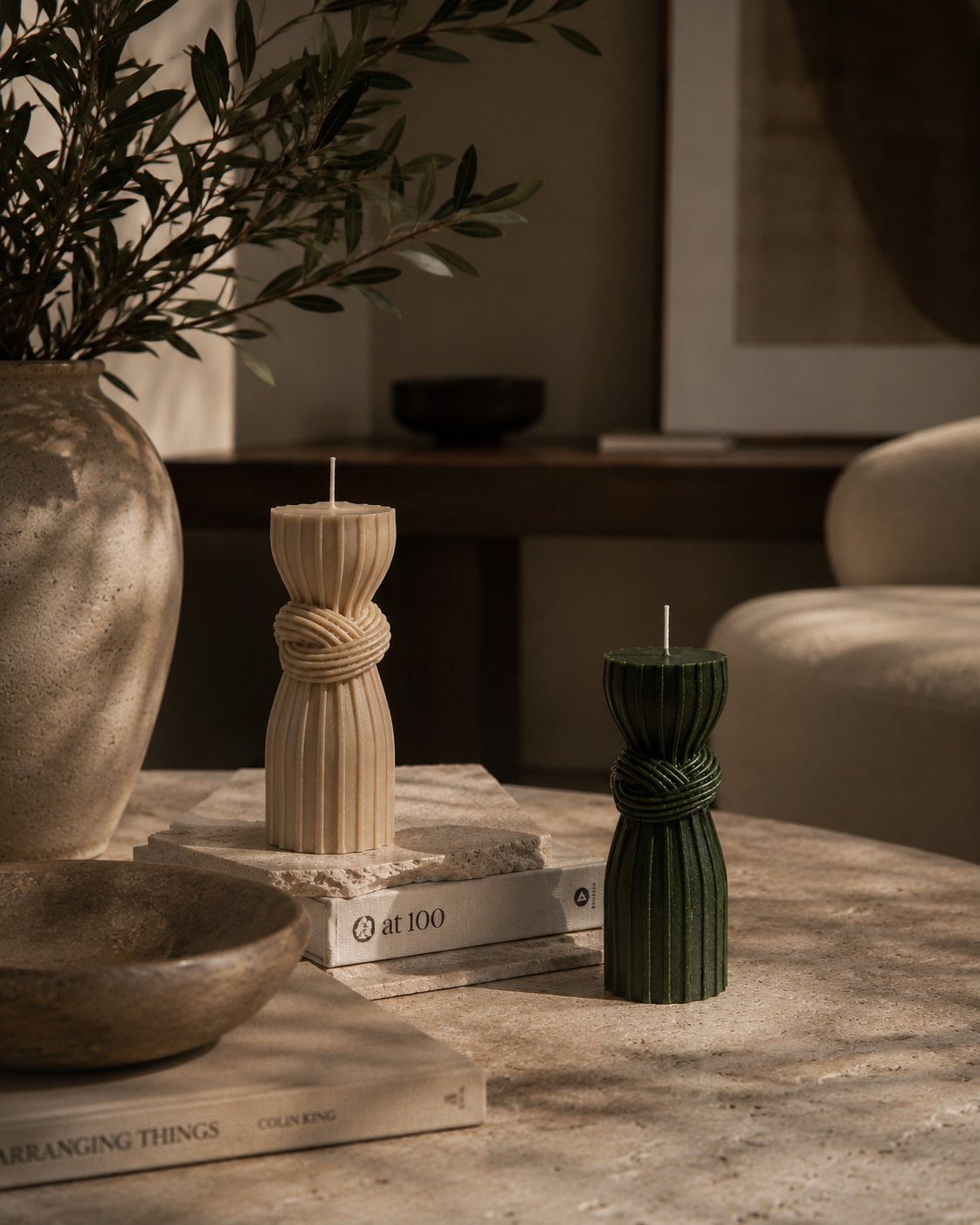 Luxury handmade sculptural candles in Moss and Cashmere displayed in a contemporary living room.