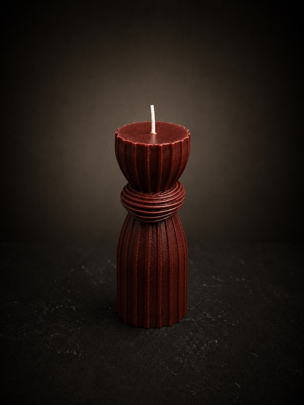 Ember Bound Column sculptural candle in deep terracotta wax on a black studio background. Handmade Australian luxury decorative candle.