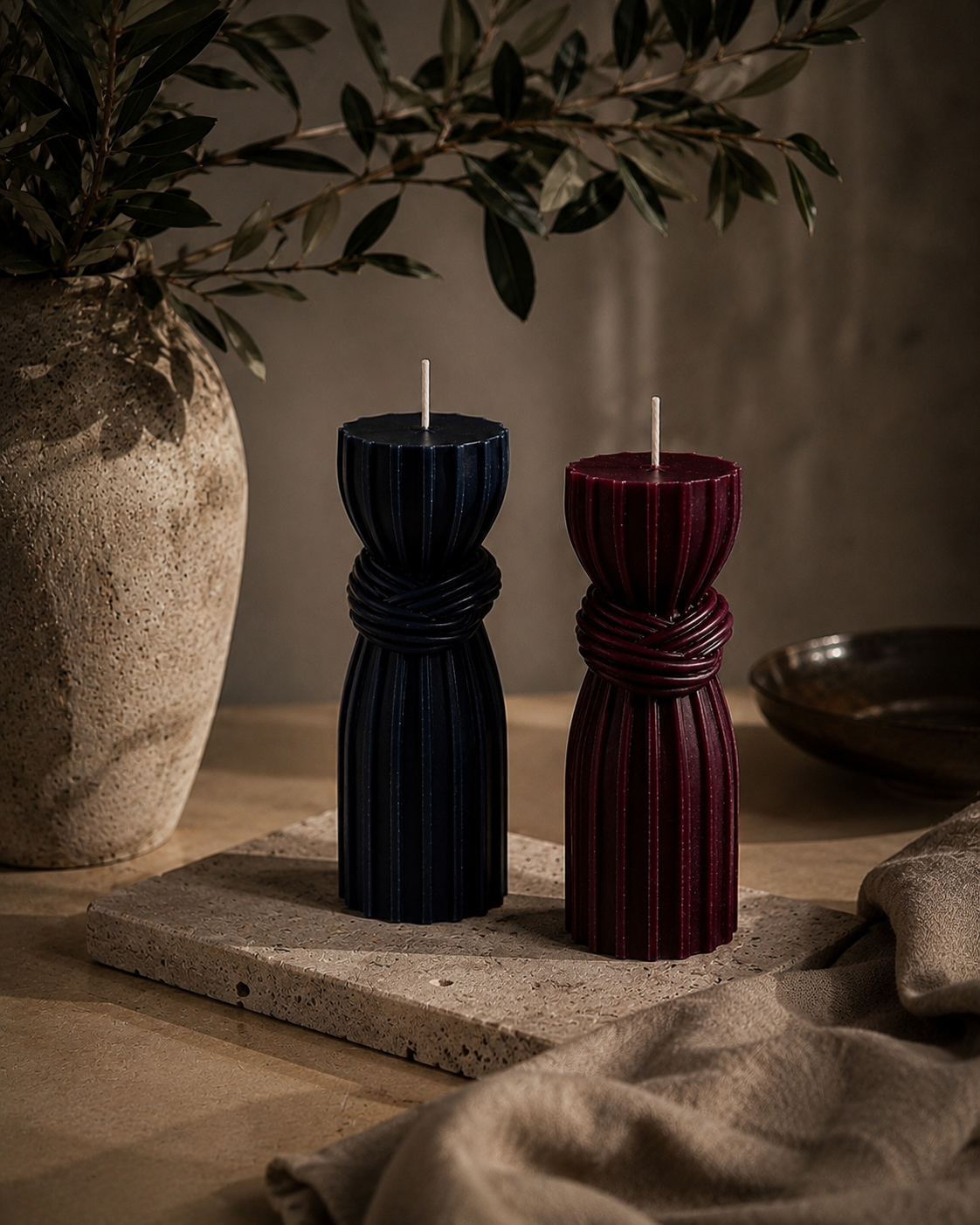 Midnight and Mulberry Bound Column sculptural candles displayed together in a sophisticated contemporary home.