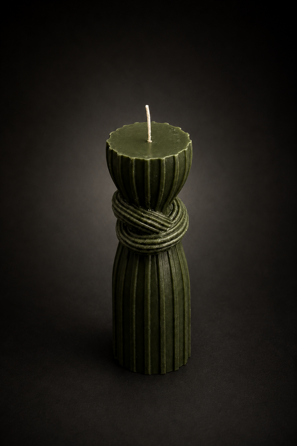 Moss Bound Column sculptural candle in deep forest green wax on a black studio background. Handmade Australian luxury decorative candle.