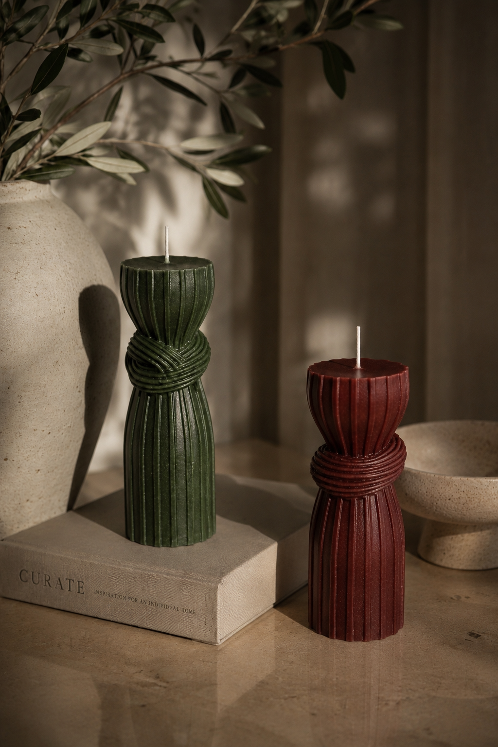 Luxury handmade sculptural candles in Moss and Ember displayed in a contemporary living room.